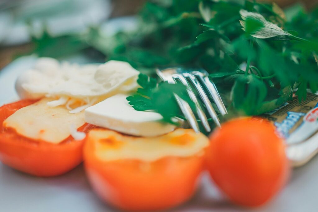 a close up of a plate of food with tomatoes and cheese